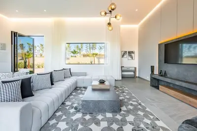 a living room with a couch and a tv at Villa Prestige Privée avec Vue Splendide in Marrakech