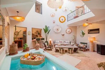 a living room with a pool in the middle of it at Riad Bahia Burgos - Exclusive - Heated Pool & Breakfast - 15 min walk Jemaa El Fnaa in Marrakech