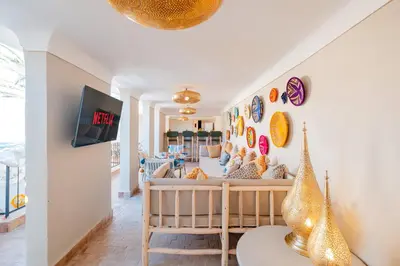 a living room with a crib and a tv at Riad Bahia Burgos - Exclusive - Heated Pool & Breakfast - 15 min walk Jemaa El Fnaa in Marrakech