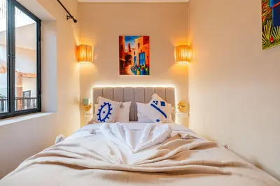 a bedroom with a bed with white sheets and a window at Riad Bahia Burgos - Exclusive - Heated Pool & Breakfast - 15 min walk Jemaa El Fnaa in Marrakech