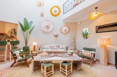 a room with a bed and chairs in it at Riad Bahia Burgos - Exclusive - Heated Pool & Breakfast - 15 min walk Jemaa El Fnaa in Marrakech