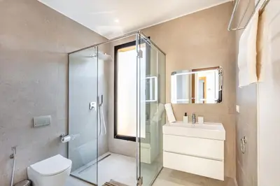 a bathroom with a shower and a toilet and a sink at Beautiful Villa 15 min Center, Jacuzzi, Padel in Marrakech