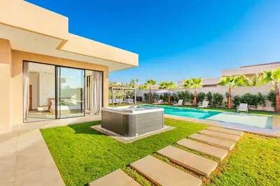 a backyard with a swimming pool and a house at Beautiful Villa 15 min Center, Jacuzzi, Padel in Marrakech