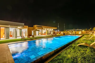 a swimming pool in front of a house at night at Prestige Villa Heated Pool Total Quiet in Marrakech