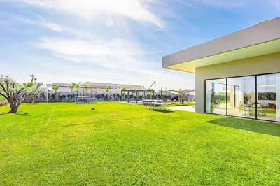 a large grassy yard with a building at Prestige Villa Heated Pool Total Quiet in Marrakech