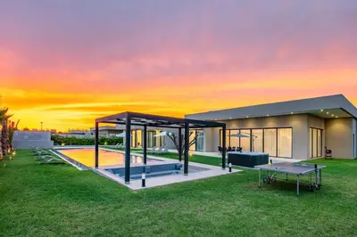 a house with a sunset in the background at Prestige Villa Heated Pool Total Quiet in Marrakech