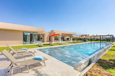 a swimming pool in the backyard of a house at Chic Villa Jacuzzi and Green Space in Marrakech