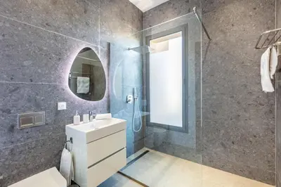 a bathroom with a sink and a shower and a mirror at Dream Getaway Intimate Villa Private Pool in Marrakech