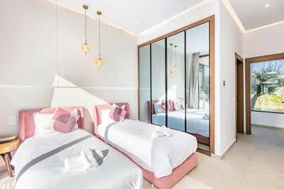 a bedroom with two beds and a mirror at Dream Getaway Intimate Villa Private Pool in Marrakech