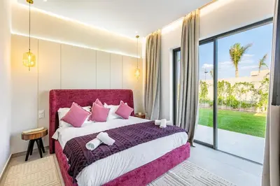 a bedroom with a large bed with pink pillows at Dream Getaway Intimate Villa Private Pool in Marrakech