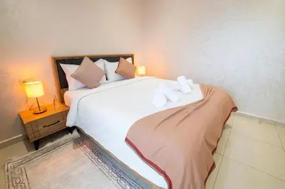 a bedroom with a large white bed with two pillows at Stylish &cosy 1-Bedroom in Marrakech