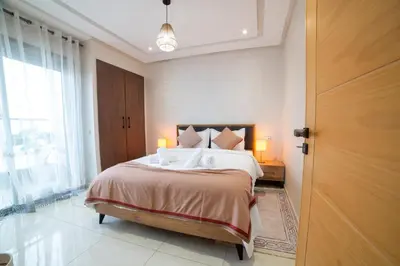 a bedroom with a large bed and a window at Stylish &cosy 1-Bedroom in Marrakech
