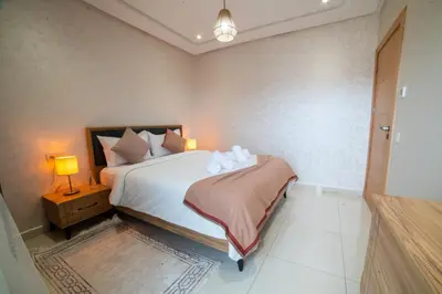 a bedroom with a bed with two pillows at Stylish &cosy 1-Bedroom in Marrakech