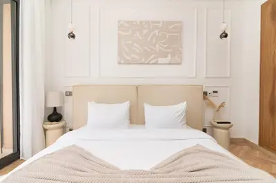 a bedroom with a large bed with white sheets at Apartment in Victor Hugo 10 minutes from Jemaa el-Fna in Marrakech