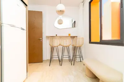 a kitchen with stools and a table in a room at Apartment in Victor Hugo 10 minutes from Jemaa el-Fna in Marrakech