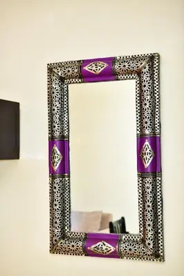 a mirror with a purple and silver frame on a wall at Marrakech Centre Guéliz – Calme & authentique in Marrakech