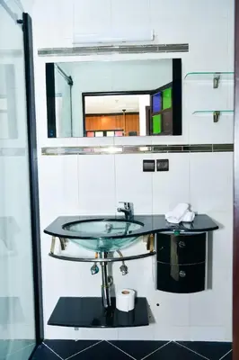 a bathroom with a sink and a mirror at Marrakech Centre Guéliz – Calme & authentique in Marrakech