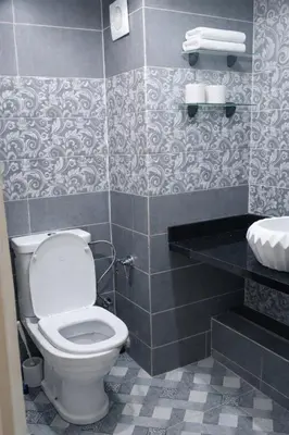 a bathroom with a white toilet and a sink at Residance la perle d'atlas appartements hivernage in Marrakech