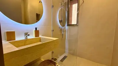 a bathroom with a sink and a mirror at Prestigia JADE Luxury and comfort Private Garden in Marrakech