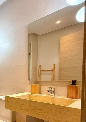 a bathroom with a sink and a large mirror at Prestigia JADE Luxury and comfort Private Garden in Marrakech