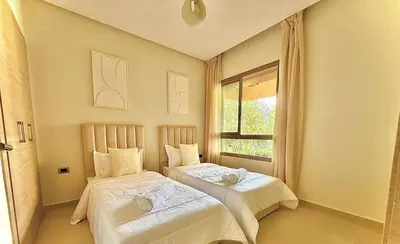 a bedroom with two beds and a window at Prestigia JADE Luxury and comfort Private Garden in Marrakech