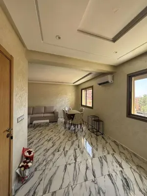 a living room with a couch and a table at Appartement à gueliz in Marrakech