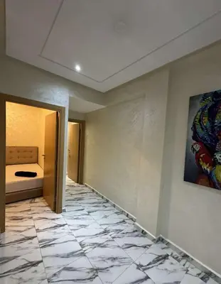 a hallway with a room with a tile floor at Appartement à gueliz in Marrakech