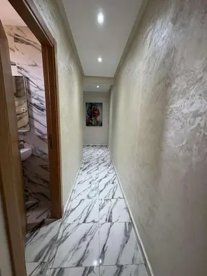 a hallway with a marble tile floor and a doorway at Appartement à gueliz in Marrakech