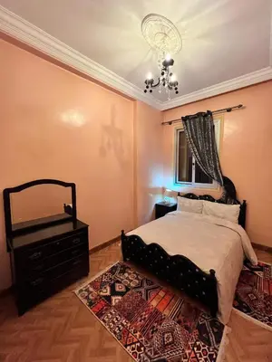 a bedroom with a bed and a mirror and a rug at Spacious Family Apartment near Jemaa el-Fnaa in Marrakech