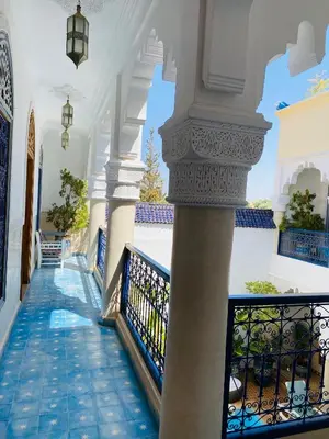 a hallway of a house with a column at Riad El Laadel Marrakech in Marrakech