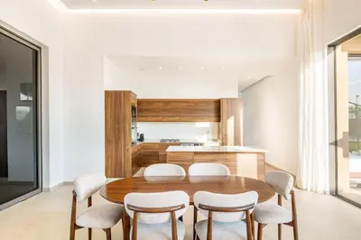 a kitchen and dining room with a wooden table and chairs at Luxury Villa with No Overlooking 15 min from Marrakech in Marrakech