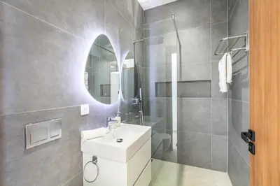 a bathroom with a white sink and a mirror at Luxury Villa with No Overlooking 15 min from Marrakech in Marrakech