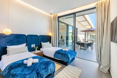 a hotel room with two beds and a balcony at Diamond Serenity House in Marrakech
