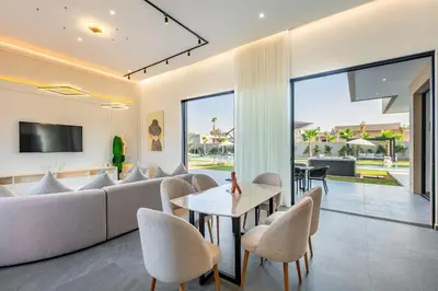 a living room with a couch and a table and chairs at Diamond Serenity House in Marrakech