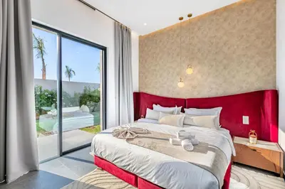a bedroom with a large bed and a large window at Diamond Serenity House in Marrakech