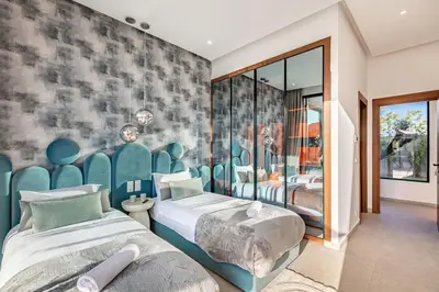 a bedroom with two beds and a wall mural at Villa Magique Piscine Chauffée Et Jacuzzi in Marrakech