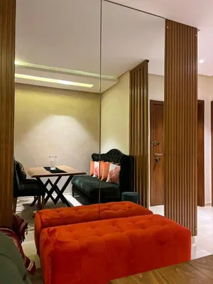 a bedroom with an orange bed and a table at Appart Essalam 2 in Marrakech