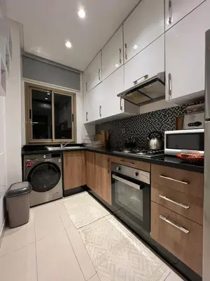 a kitchen with a washer and dryer in it at Appart Essalam 2 in Marrakech