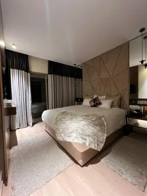 a bedroom with a large bed in a room at Appart Essalam 2 in Marrakech