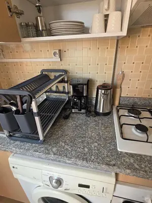 a kitchen counter with a drying rack and a stove at apartt le Palmier de Guéliz in Marrakech