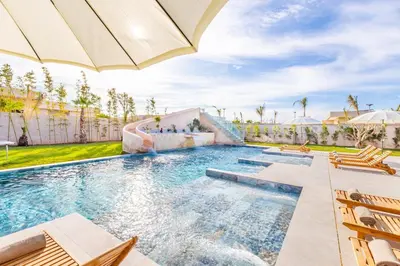 a swimming pool with a slide in a house at Luxury villa with spa, gym and cinema 15 min from center in Marrakech