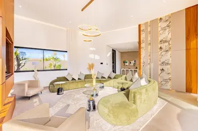 a living room with couches and a table at Luxury villa with spa, gym and cinema 15 min from center in Marrakech