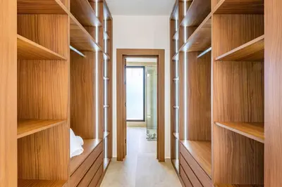 a hallway with wooden shelves in a house at Luxury villa with spa, gym and cinema 15 min from center in Marrakech