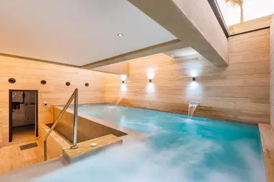 a swimming pool in a building with a swimming pool at Luxury villa with spa, gym and cinema 15 min from center in Marrakech