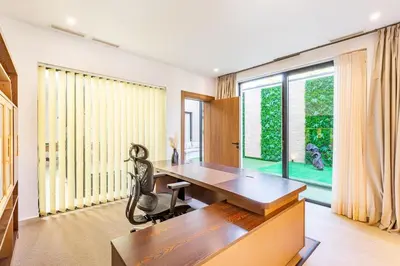 an office with a wooden desk and a chair at Luxury villa with spa, gym and cinema 15 min from center in Marrakech