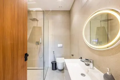 a bathroom with a shower and a sink and a mirror at Luxury villa with spa, gym and cinema 15 min from center in Marrakech