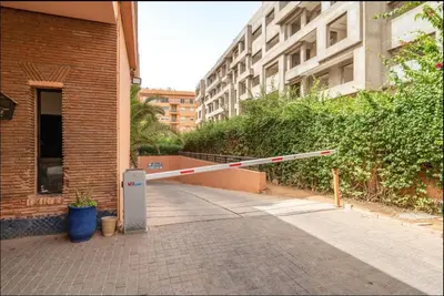 a barricade on a sidewalk in front of a building at Luxe Hivernage Piscine Géante & Terrasse XXL in Marrakech