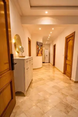 a hallway of a room with a counter and a kitchen at Luxe Hivernage Piscine Géante & Terrasse XXL in Marrakech
