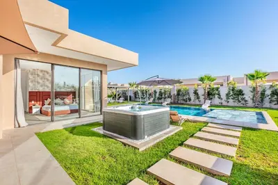 a house with a hot tub in the yard at Villa with jacuzzi in Marrakech