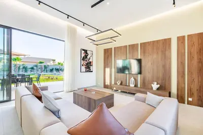 a living room with a couch and a tv at Villa with jacuzzi in Marrakech
